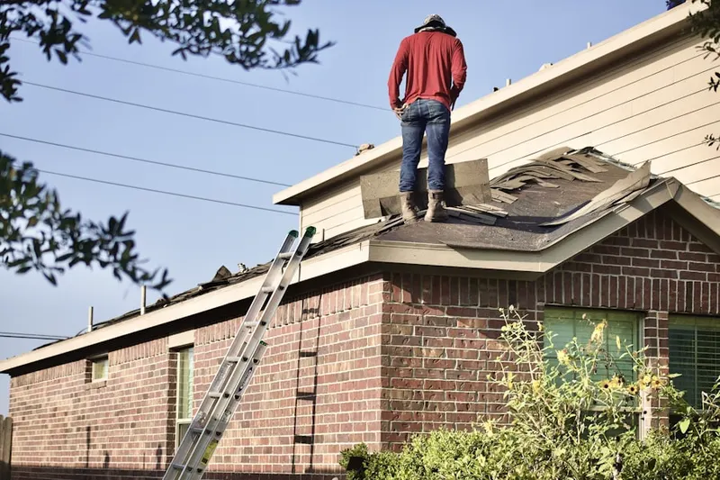 Professional roofer working on a residential roof in Calusa
